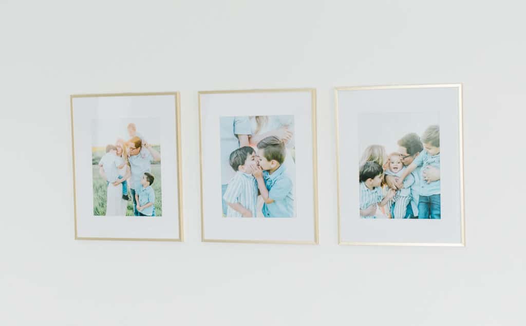 Three gold frames with white mattes from target display beloved family images.